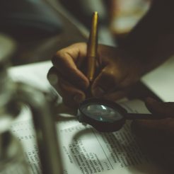 Magnifying glass looking at a document