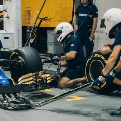 Mechanics changing wheels on car